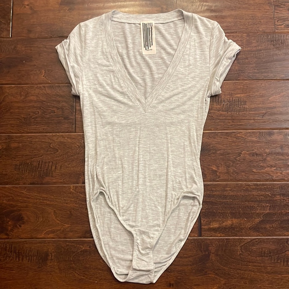 Free people heathered gray body suit with snap button, deep vneck has stretch